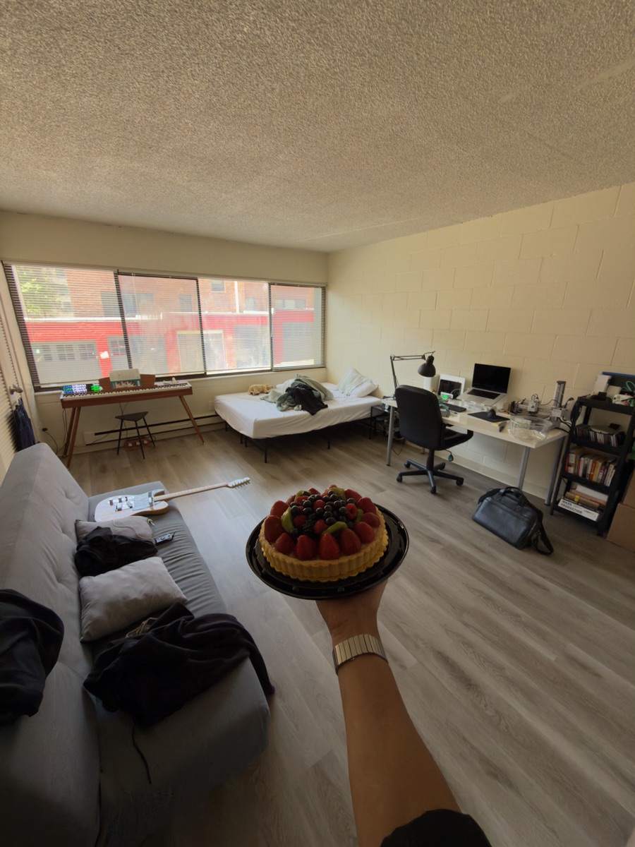 My apartment one year in, holding a fruit tart
